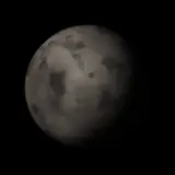 Artist's impression: the rock-warm look, for radius below 1.6 R⊕, Teq 350 to 1,000 K: bare dark rock with craters, no rim. A still of the look, not of a particular planet.